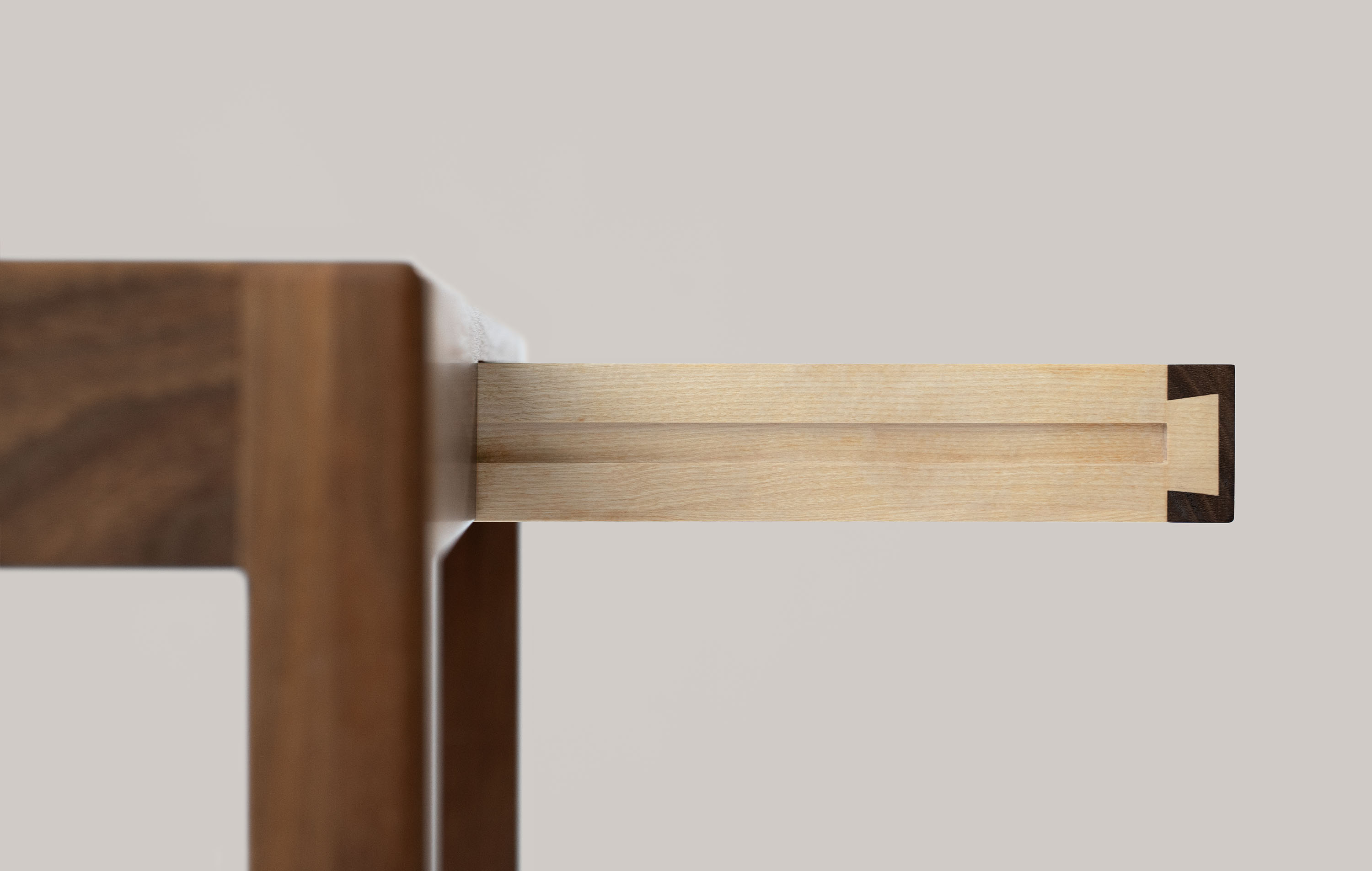 Detail of a hand-cut wood joint in the desk